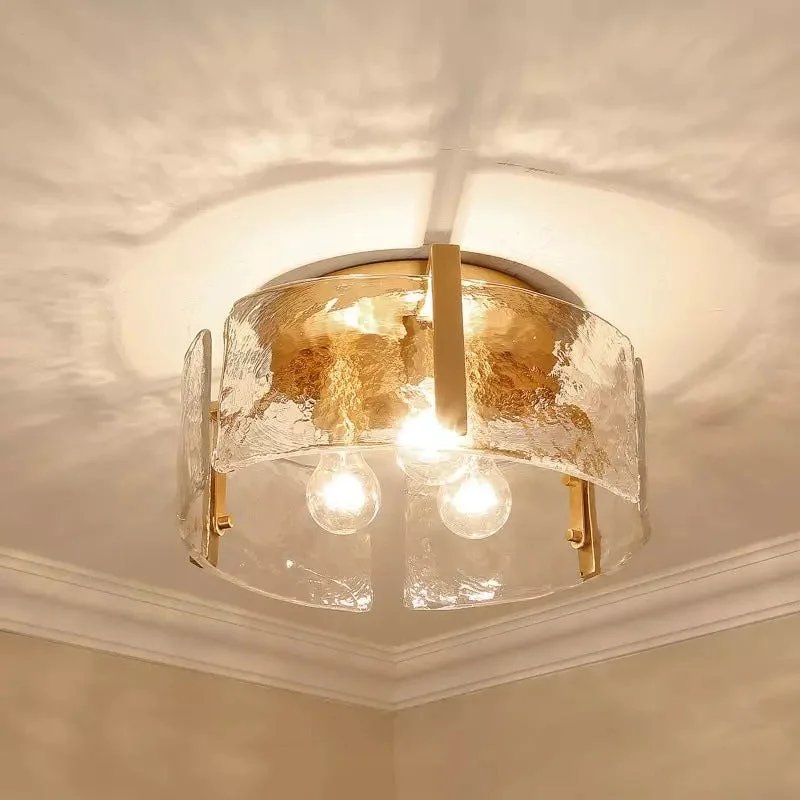 Lucien gold-toned ripple glass ceiling light above a stair landing with framed art