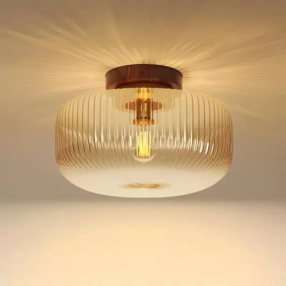 Single bulb illuminating the textured amber glass shade and nearby ceiling