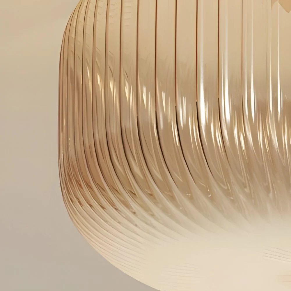 Close-up of fine vertical ribs curving around the amber glass shade