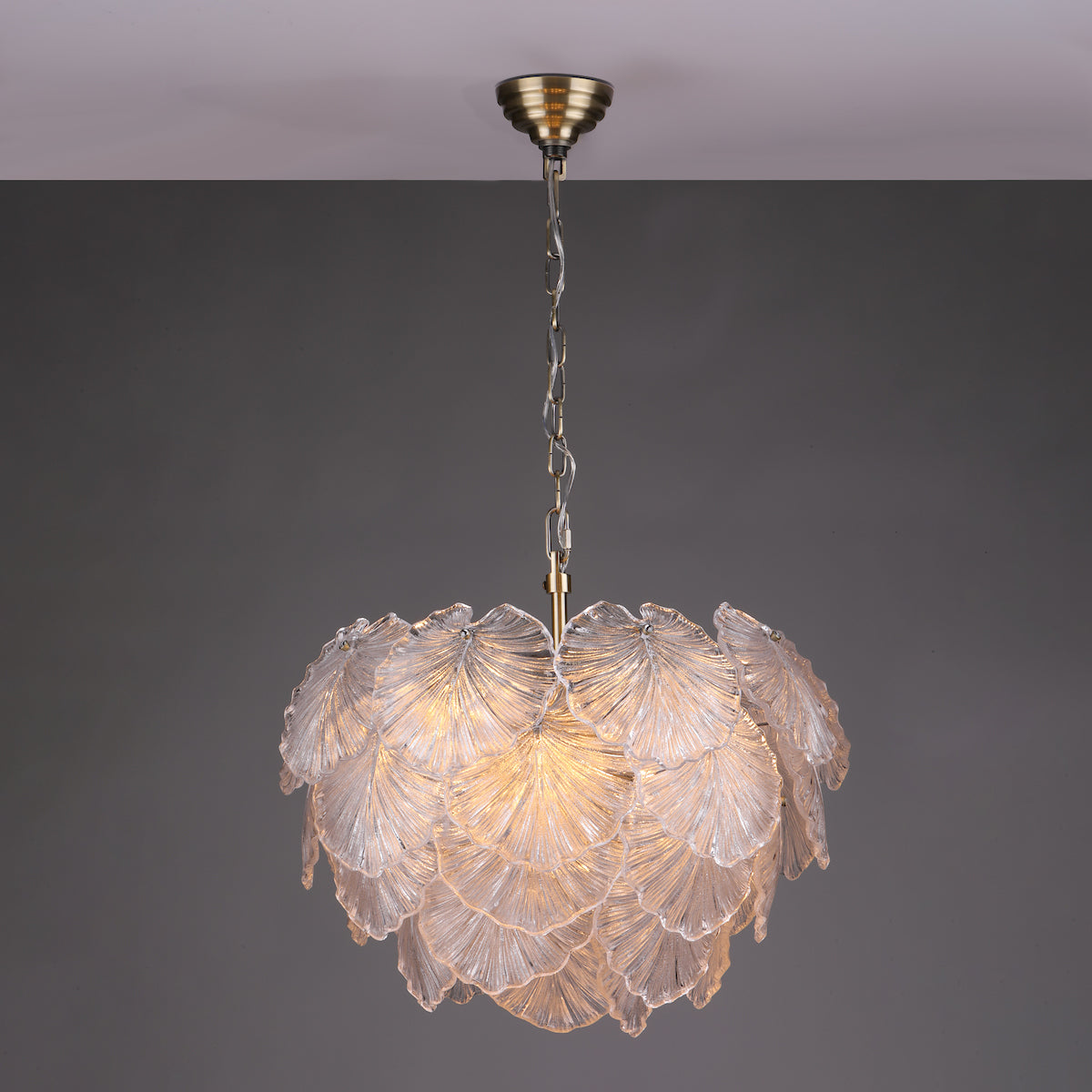 Courtney glass leaf chandelier against a dark wall
