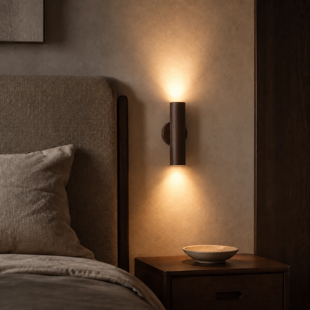 Walnut wall sconce with warm 3000K light beside a bed