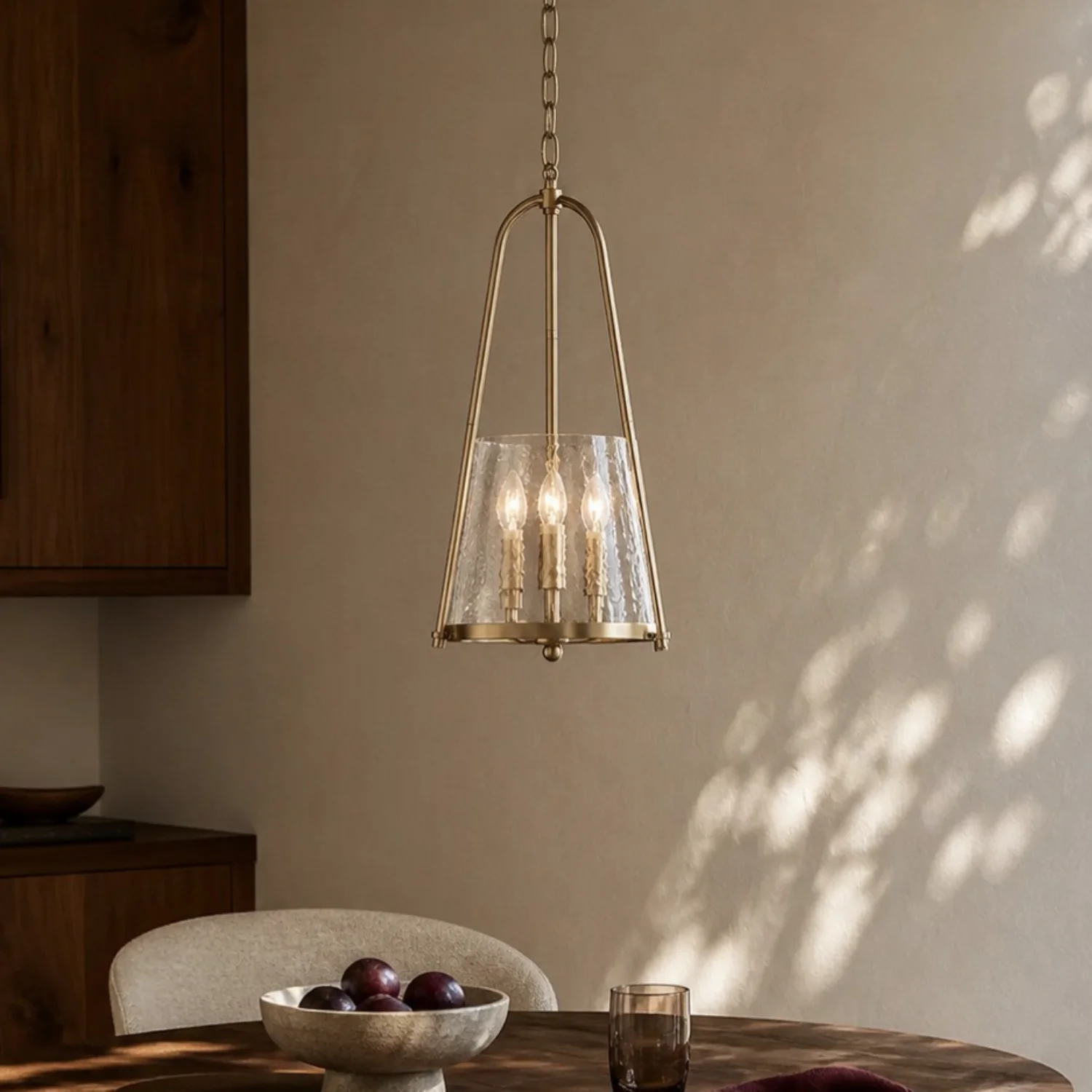 Champagne Bronze pendant above a dining table