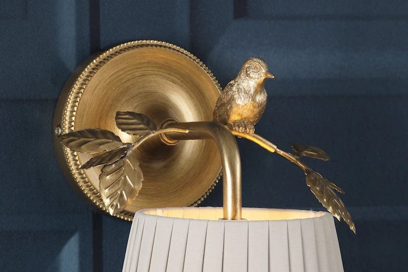 Close detail of the pleated shade and aged-brass leaves
