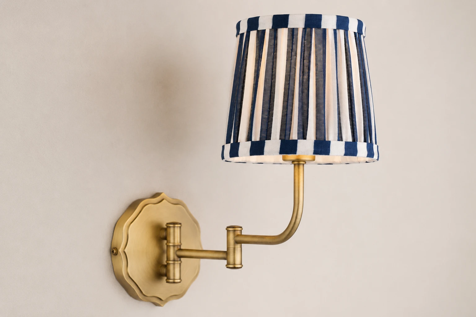 Close view of Denwick striped fabric shade and antique brass wall fitting
