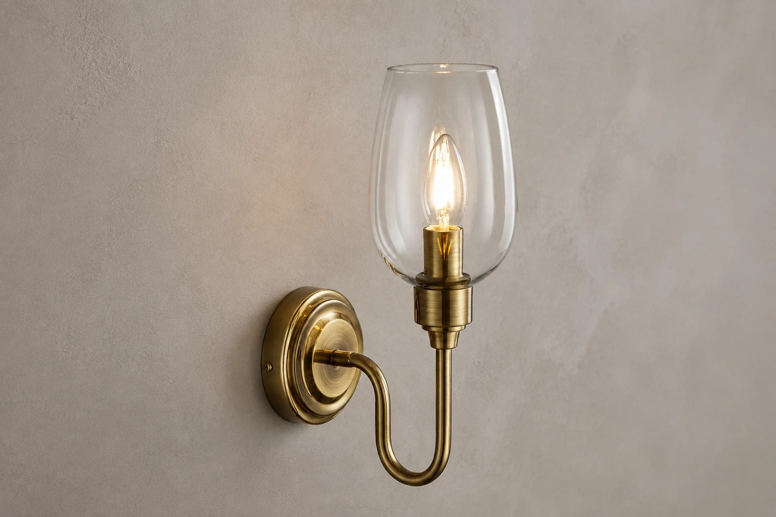 Close material view of the Amos clear glass shade and antique brass frame