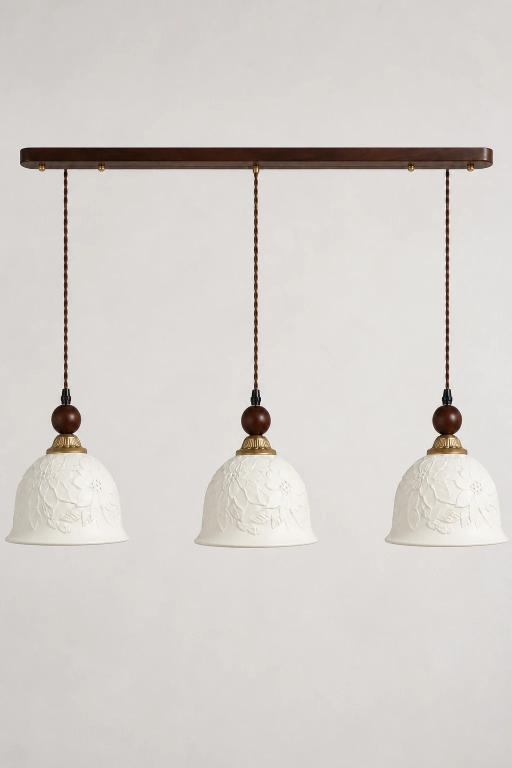 Complete triple floral relief ceramic pendant on a clean neutral studio background