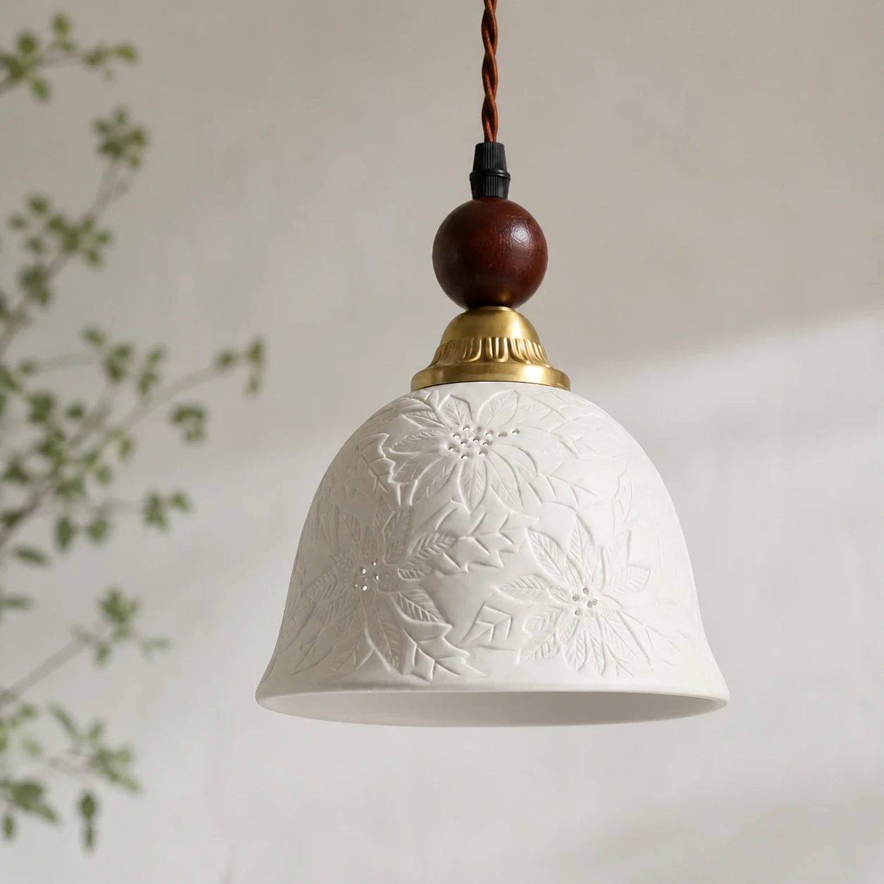 Three-quarter profile showing the ceramic bell shape and floral surface relief