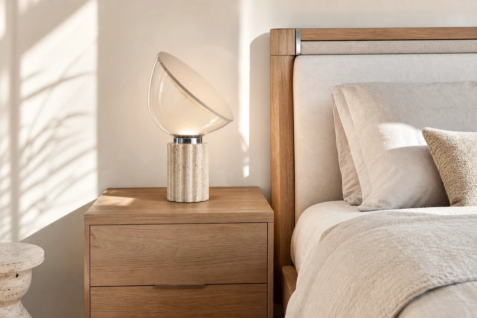 Small Soline lamp beside a bed.