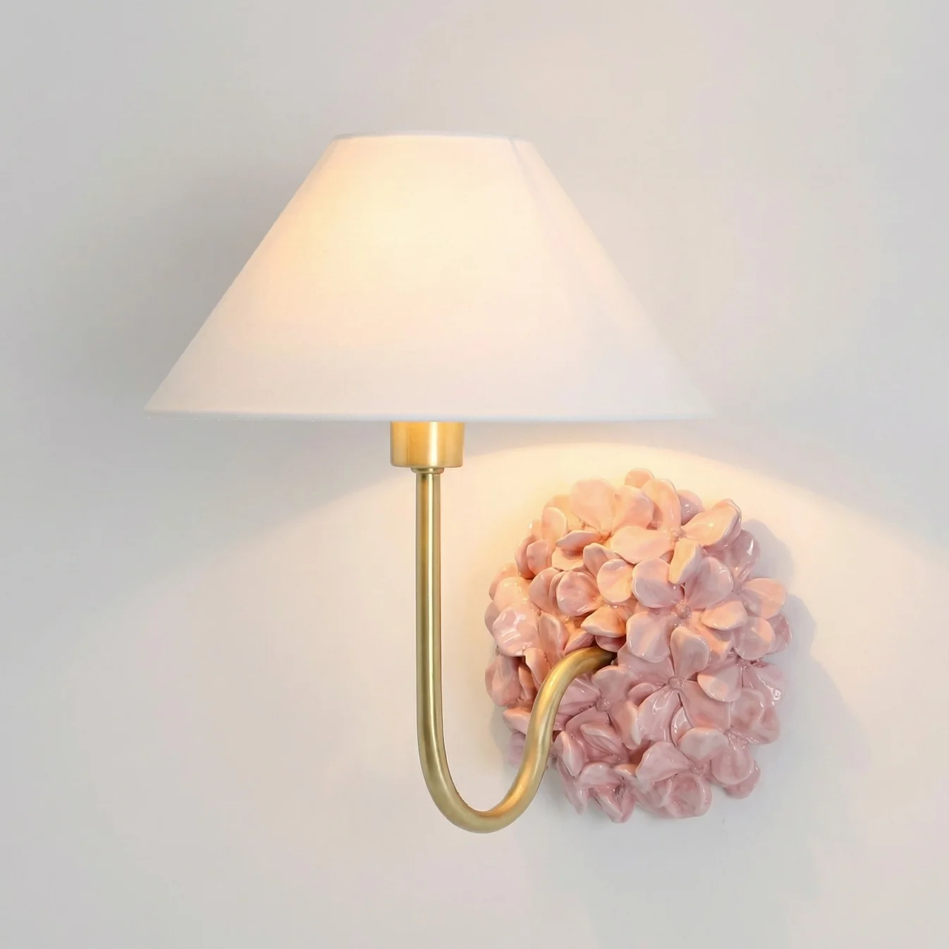 Pink Florienne floral wall sconce with an ivory linen shade