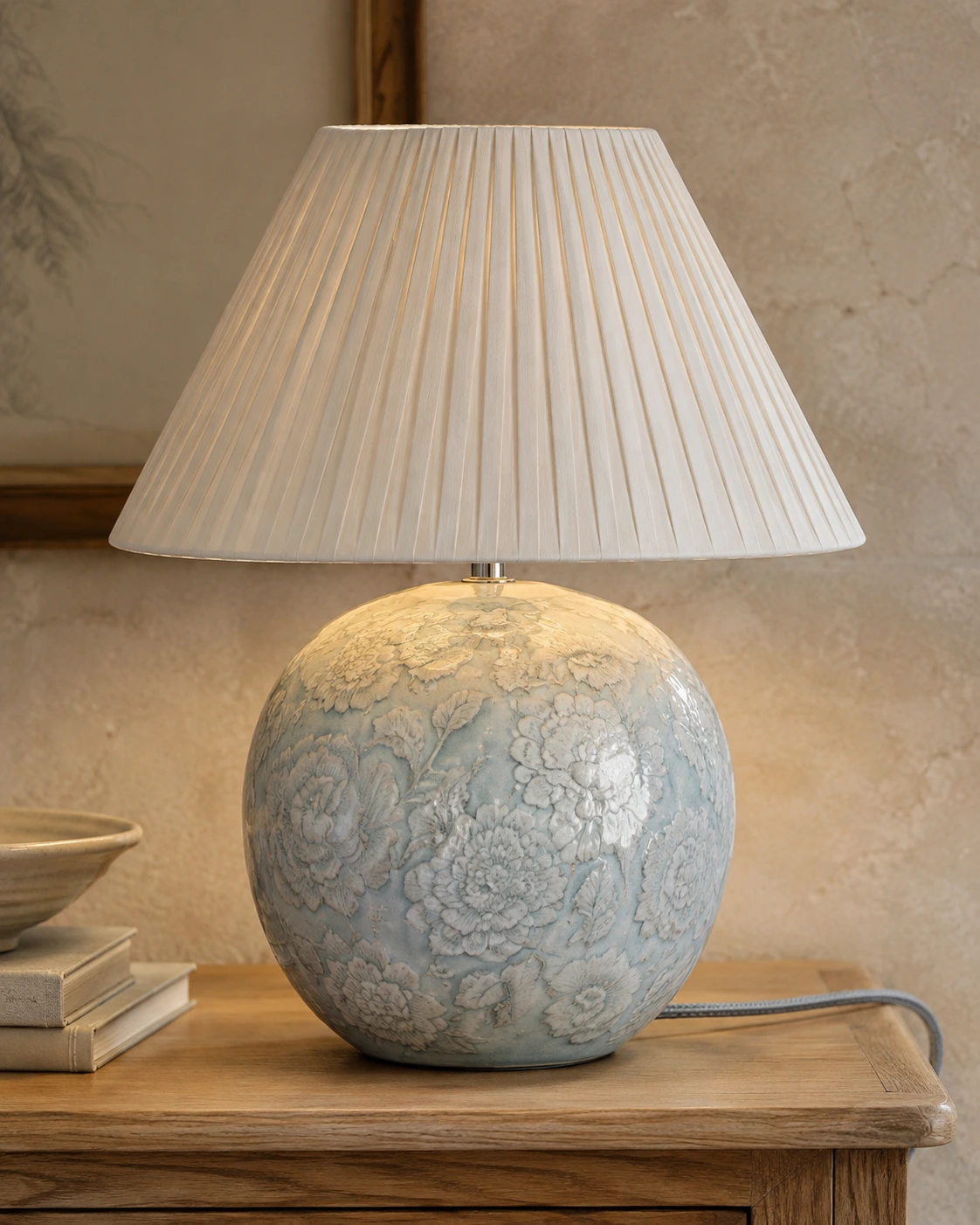 Raised floral relief on the pale blue ceramic lamp base