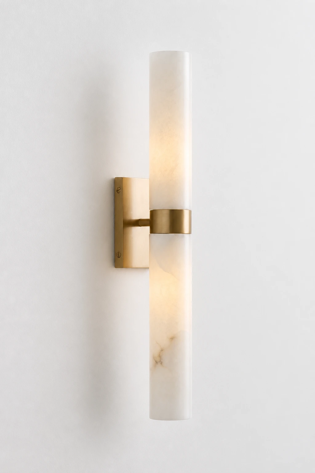 Tumbled Brass Dani double-tube alabaster wall sconce on a pearl-white background