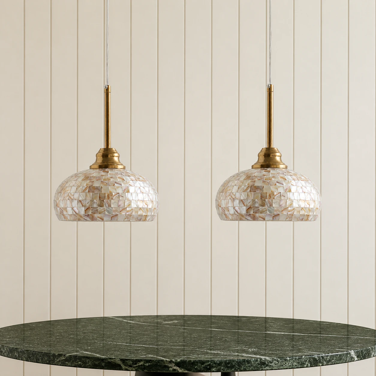 Two matching brass mother-of-pearl pendants above a small table