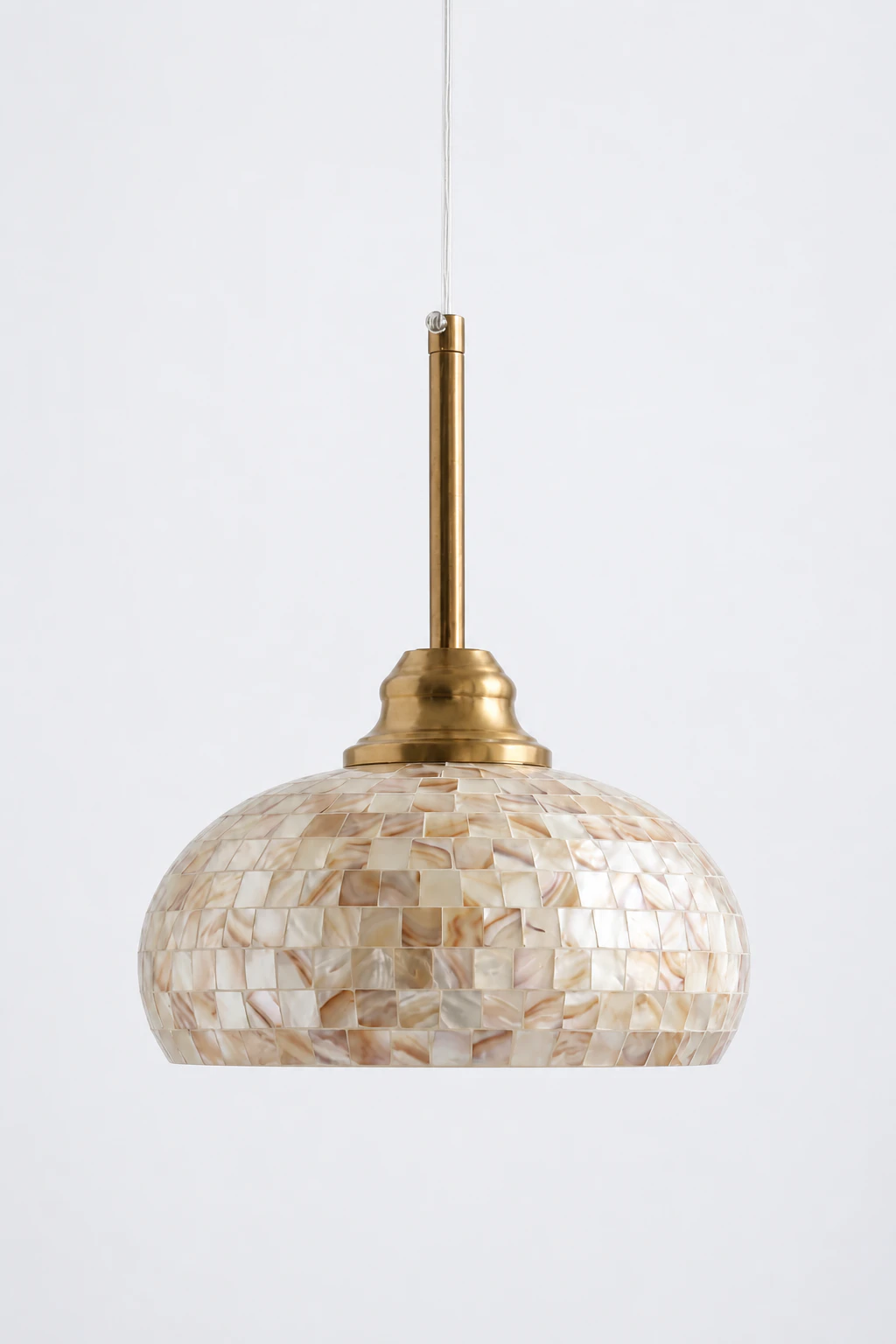 Complete natural brass and white shell mosaic pendant on a pearl-gray studio background