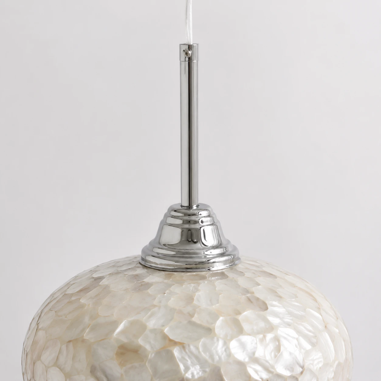 Clear suspension cable, polished chrome tube, stepped cap, and shell shade connection