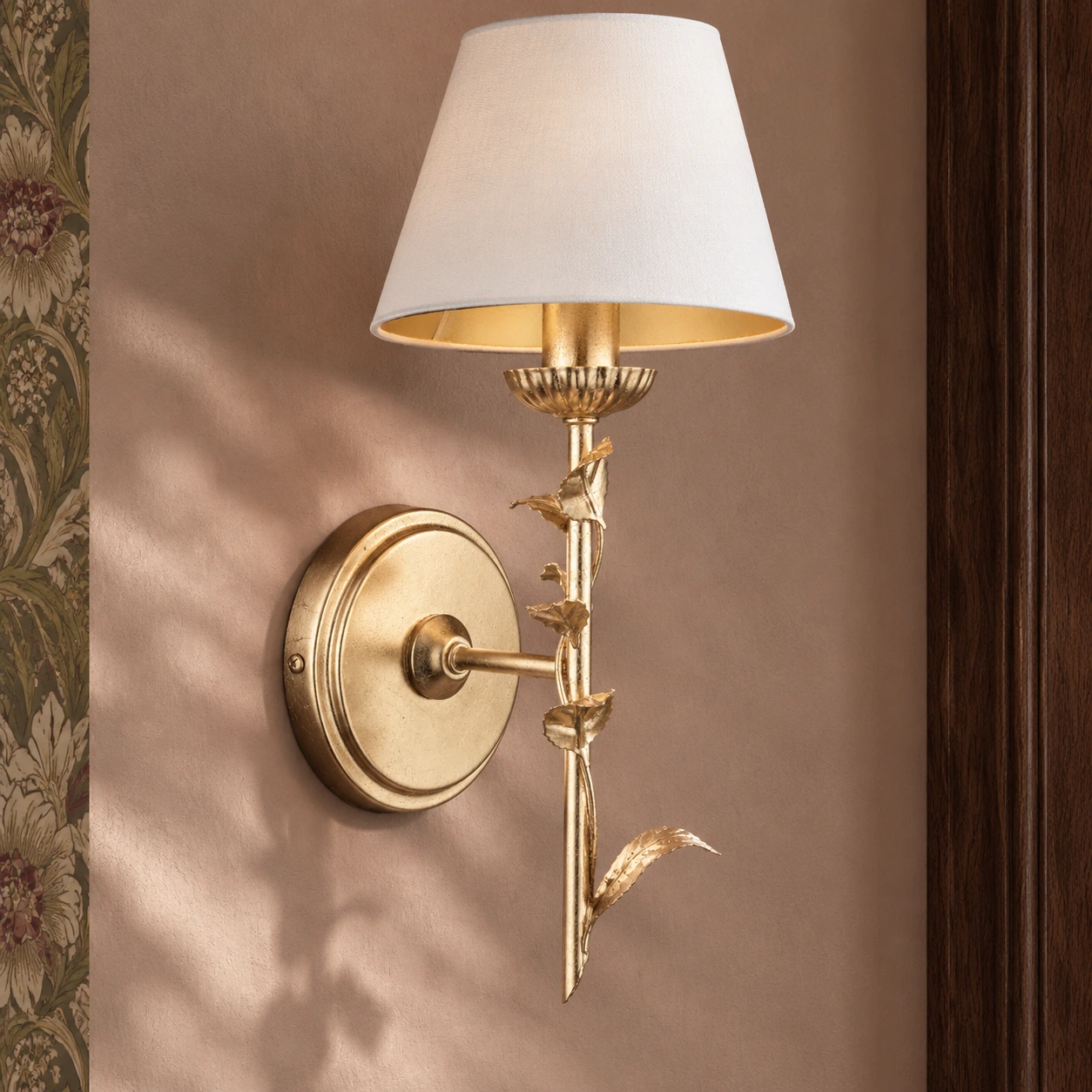 Close view of the Halton wall light sculpted botanical stem and curved leaf detail