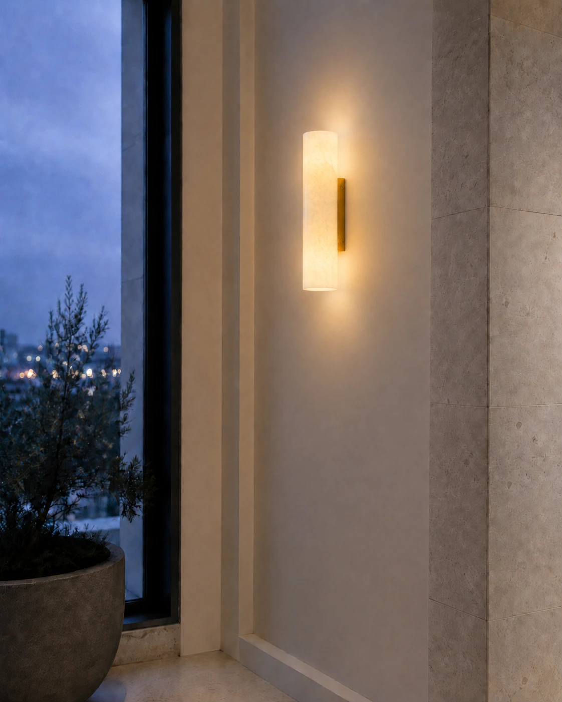 Single Brass Doran sconce glowing softly at twilight