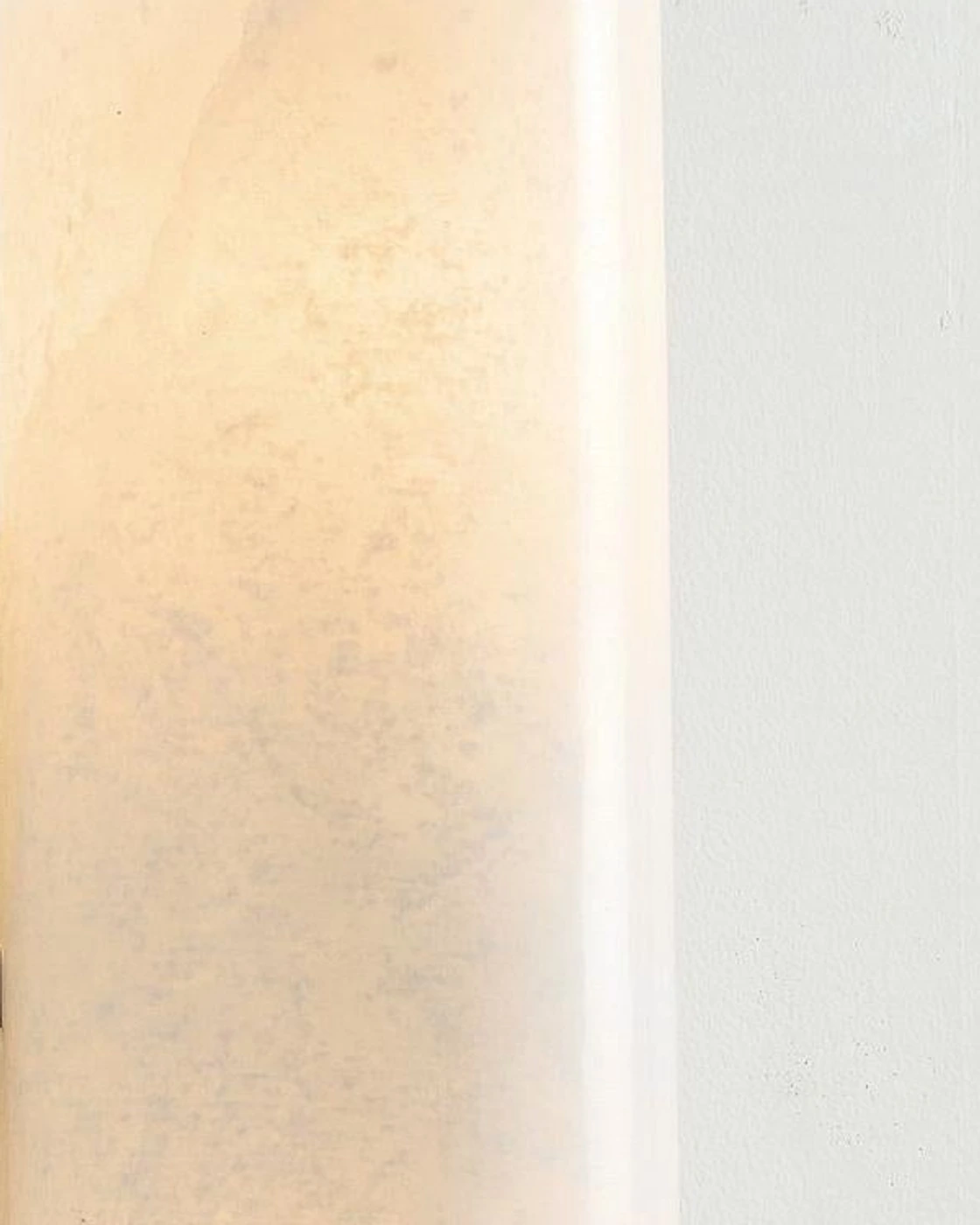 Macro detail of the softly illuminated natural alabaster cylinder and mineral veining