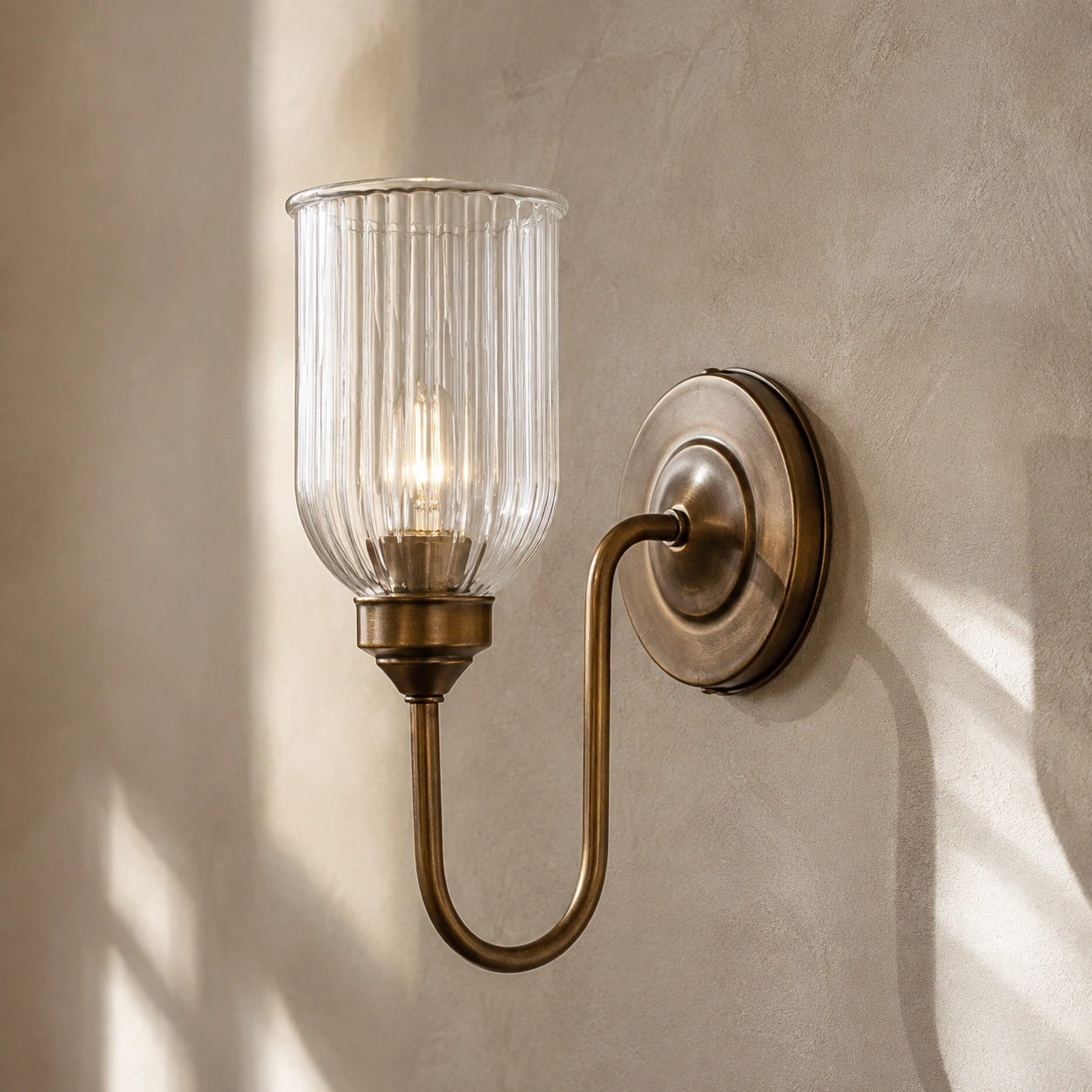 Complete burnished brass Menae wall sconce profile mounted flush to a wall
