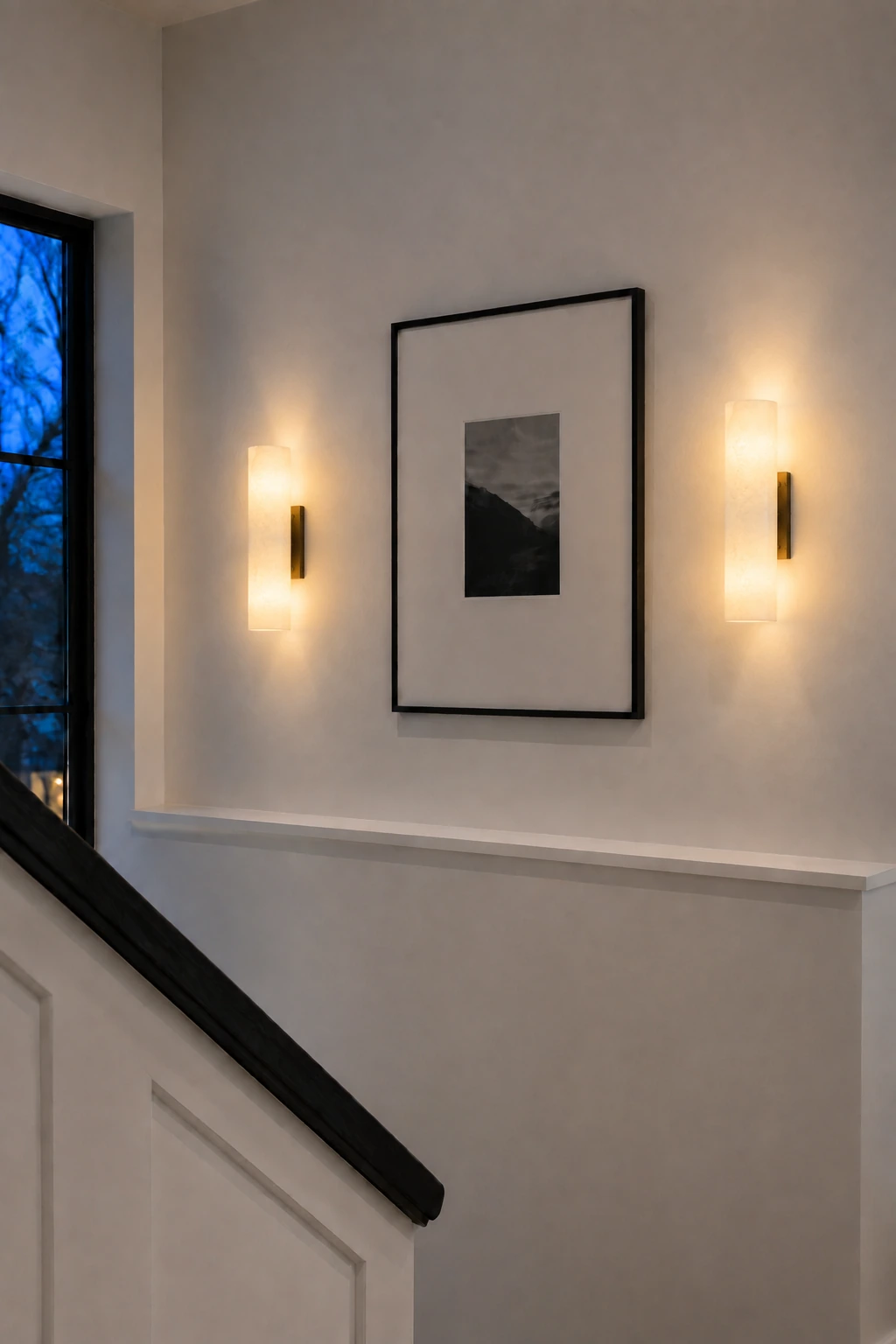 Pair of Bronze Doran sconces on a blue-hour stair landing