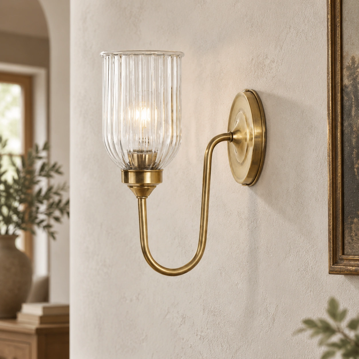 Complete antique brass Menae wall sconce profile mounted on warm plaster