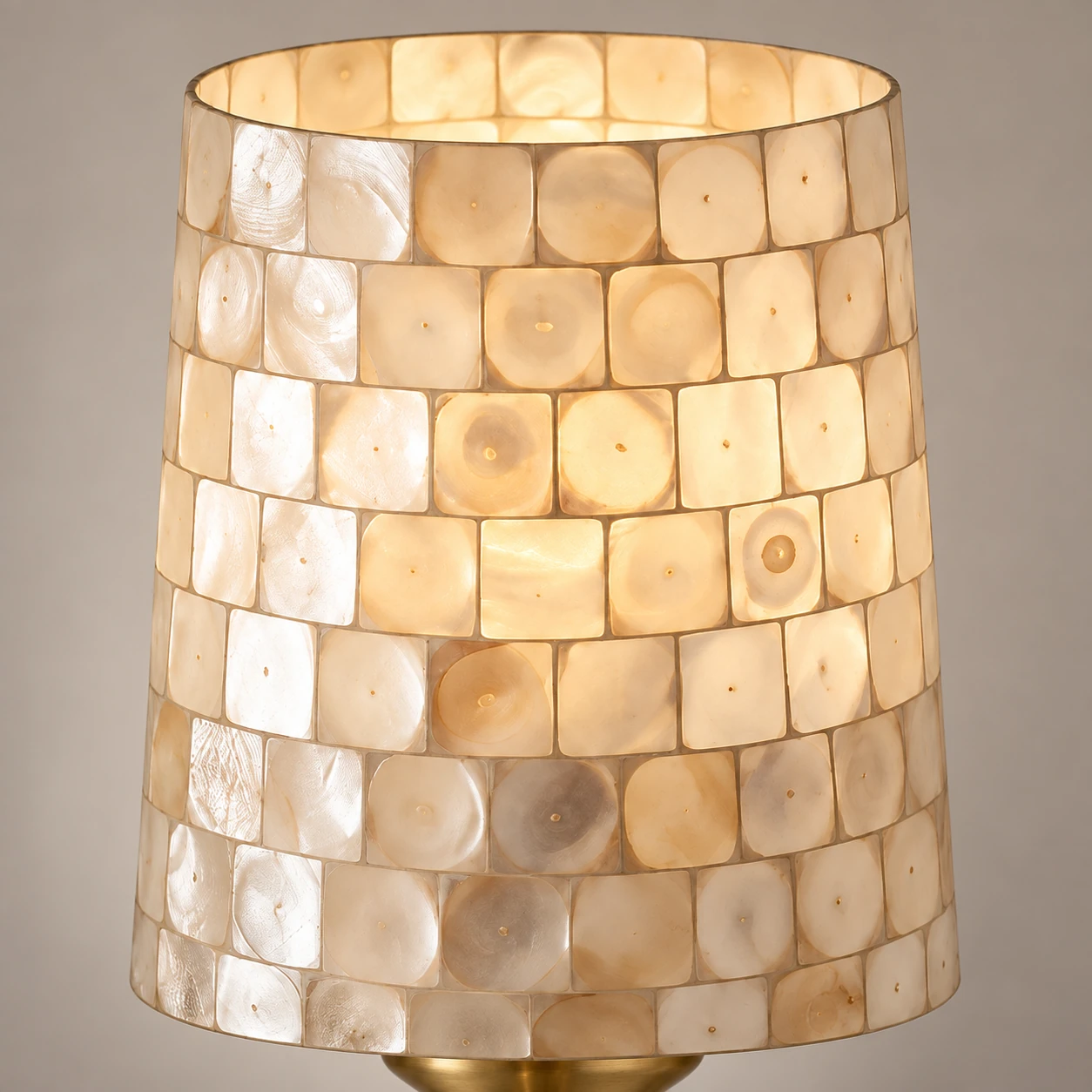 Illuminated shell shade showing its curved shape and translucent tiles
