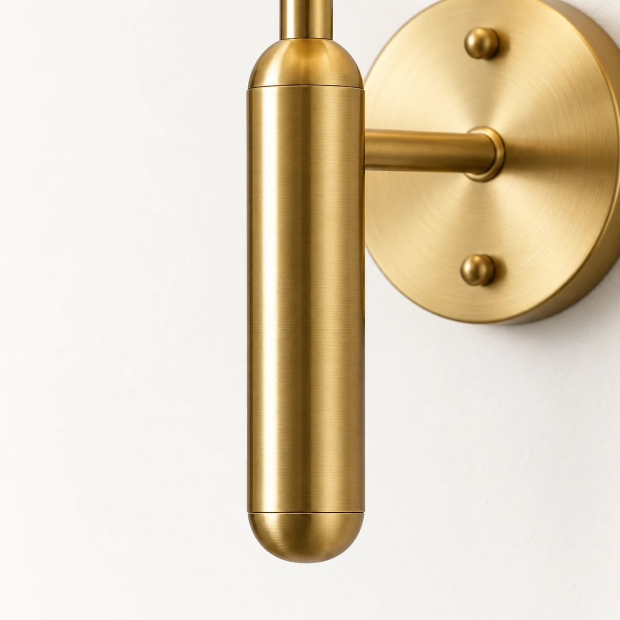 Close view of the rounded end of the cylindrical brass stem