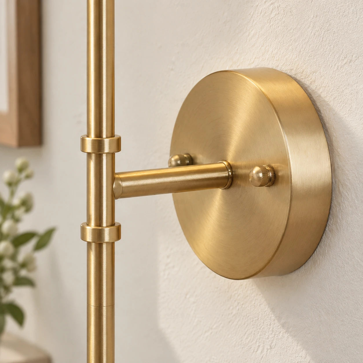 Brass round wall plate, fixing caps and straight support arm in close view