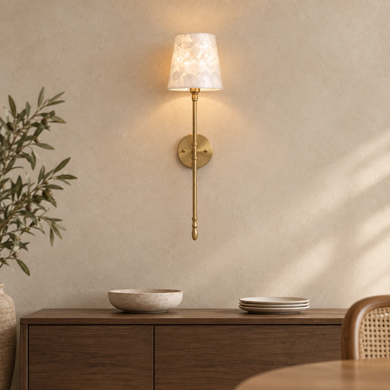 Brass and shell wall light installed above an oak dining-room sideboard