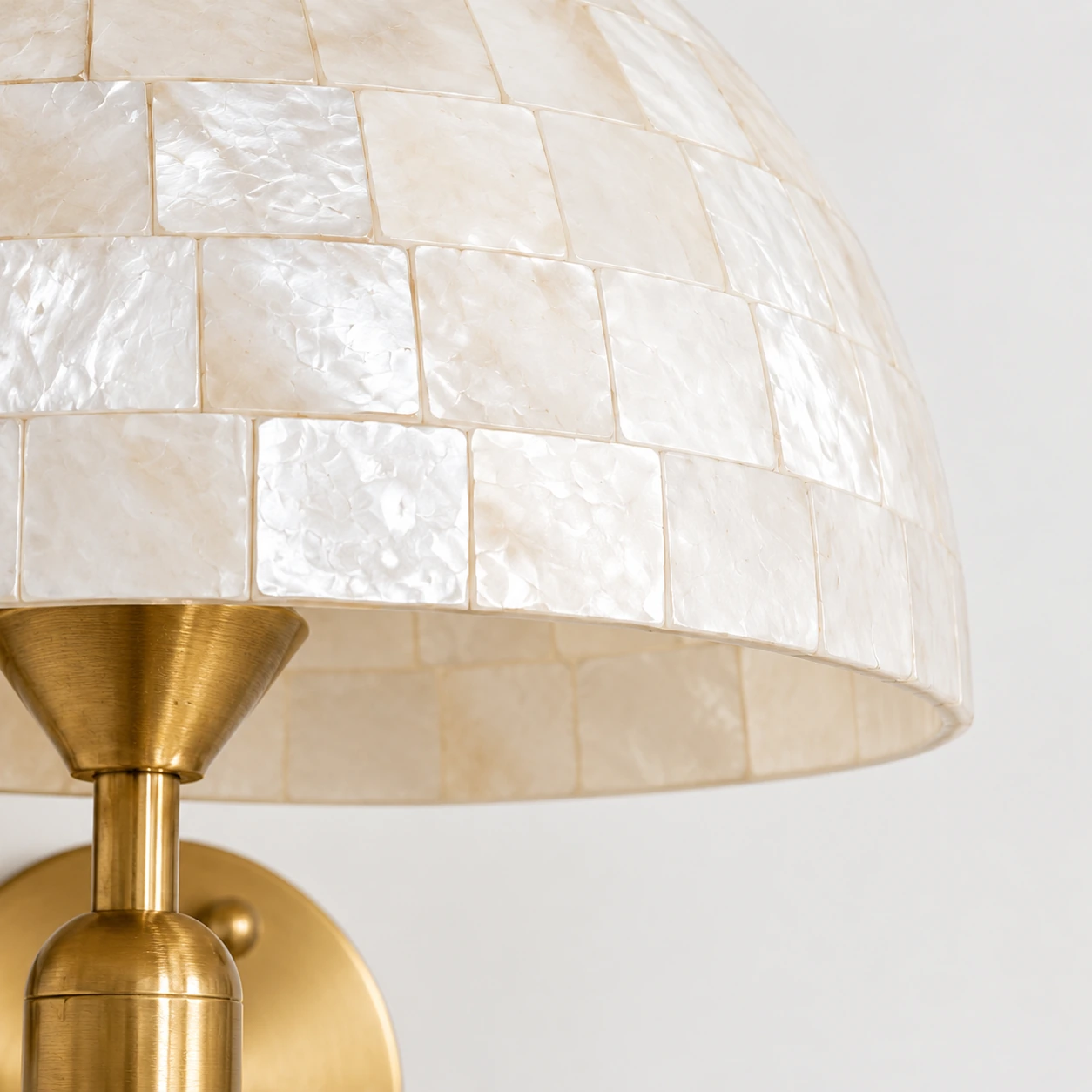 Close view of the curved edge of the white shell mosaic shade