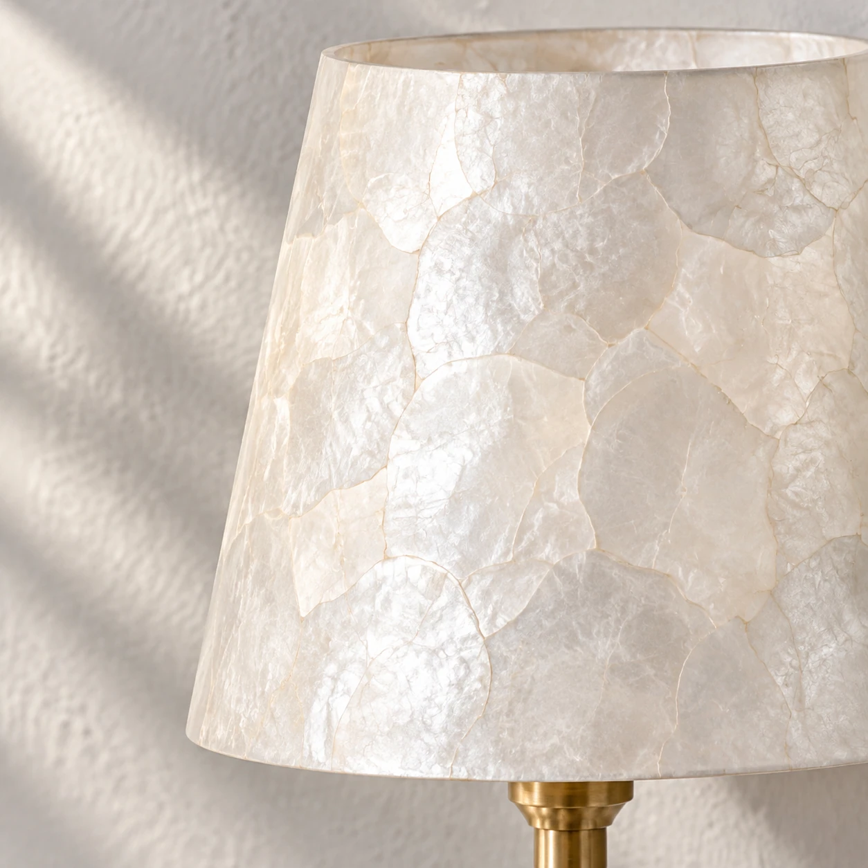 Close view of the ivory shade with irregular pearlescent shell mosaic pieces