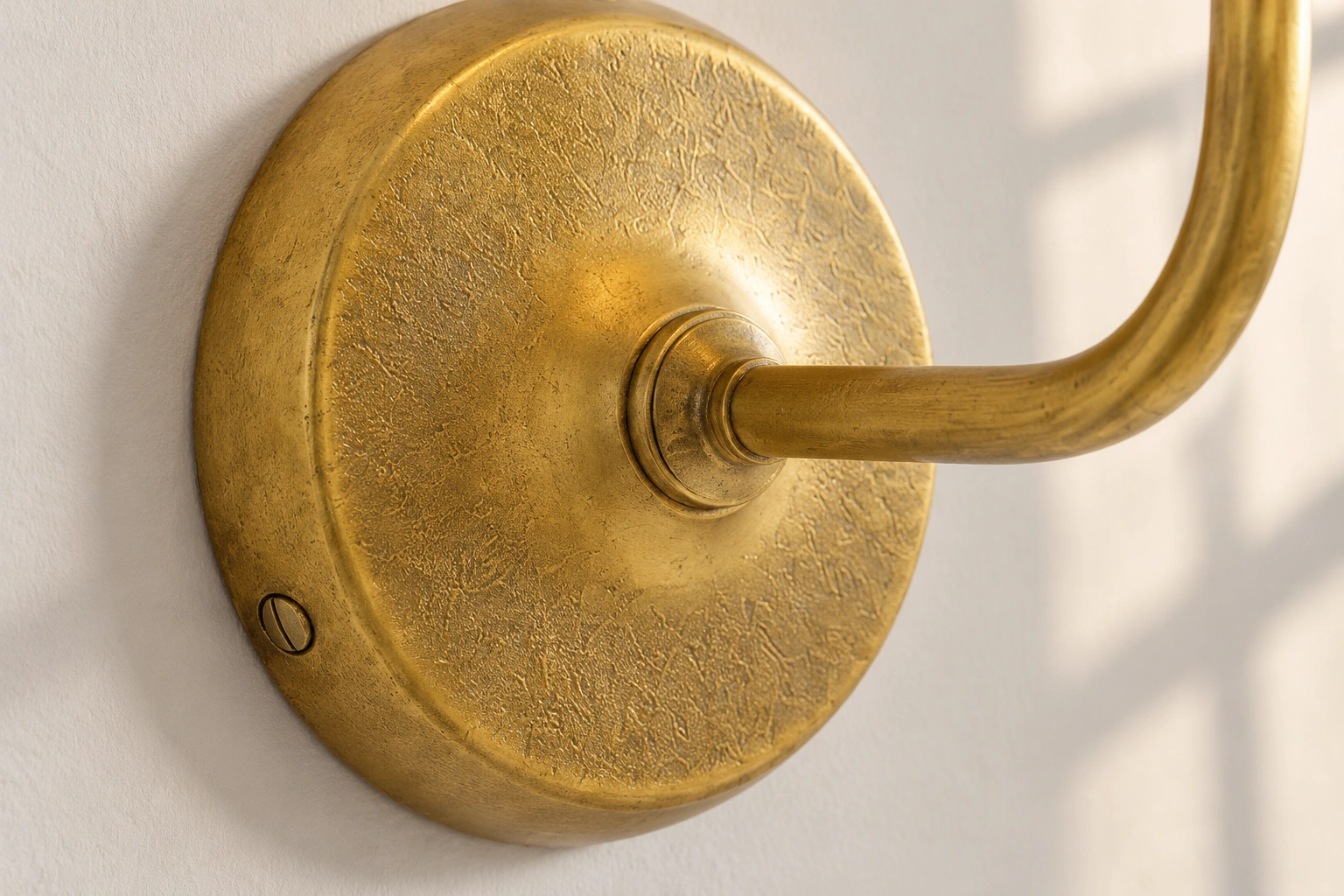 Close view of the textured wall plate and arm connection