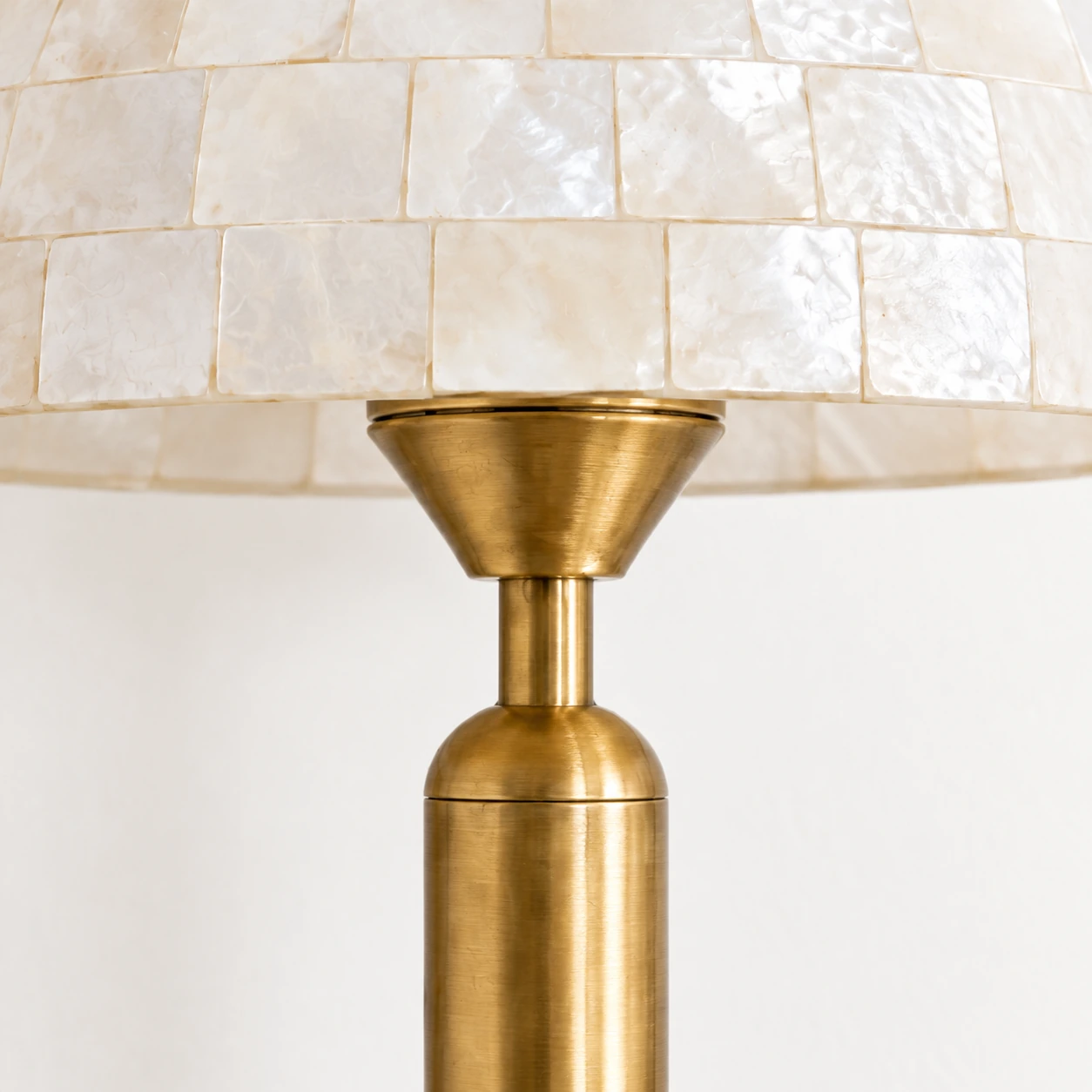 Gold tapered support and cylindrical stem beneath the shell shade
