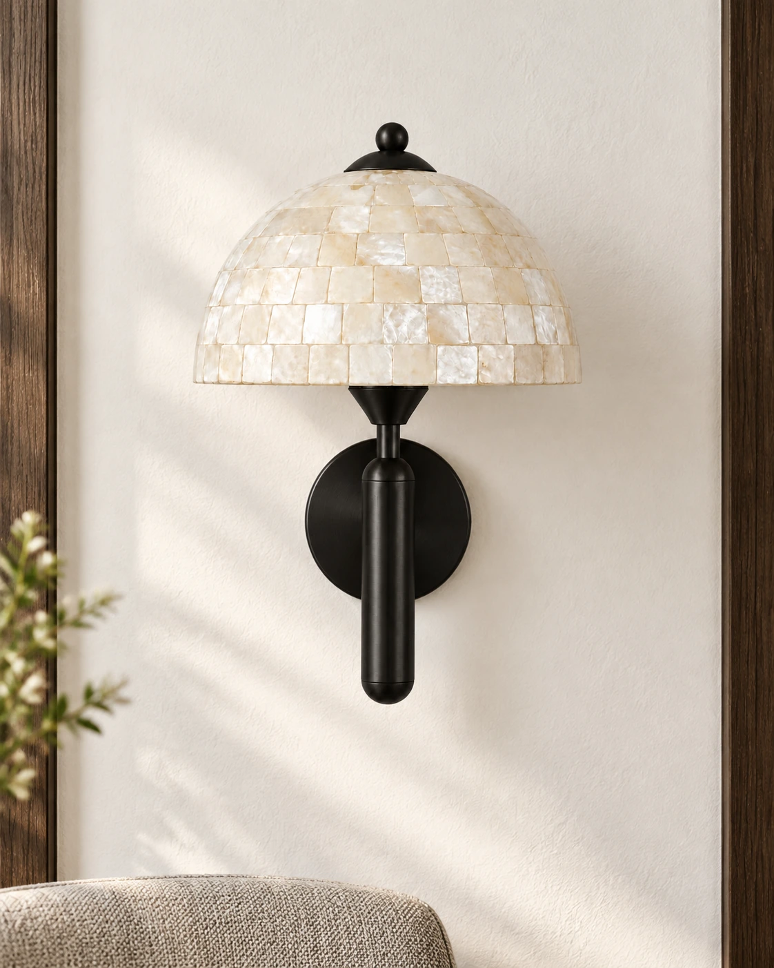 Complete black shell wall sconce on a bright wall with restrained wood detailing