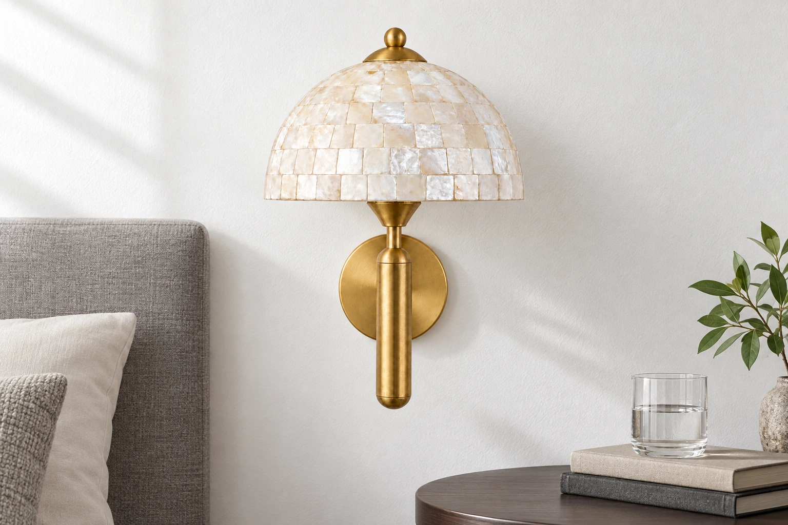 Gold Nerelle shell dome wall sconce in a bright bedroom corner