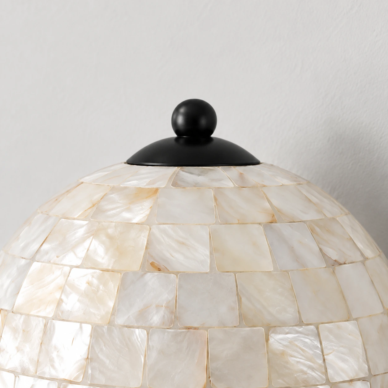 Black finial and top cap against the pearlescent shell dome