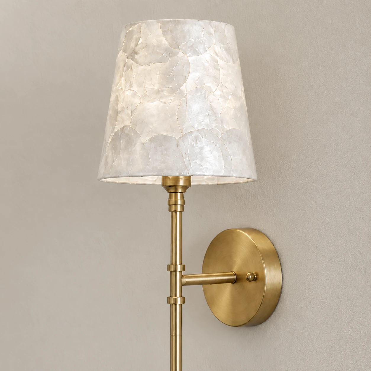 Tapered shell shade and brass neck viewed at close range