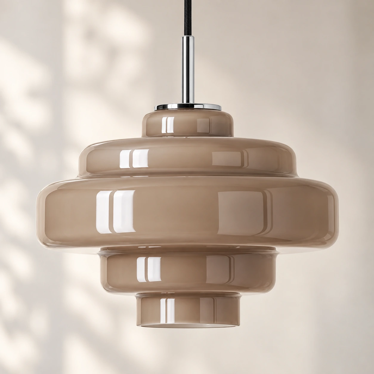 Full stepped profile of the taupe glass pendant shade and chrome stem