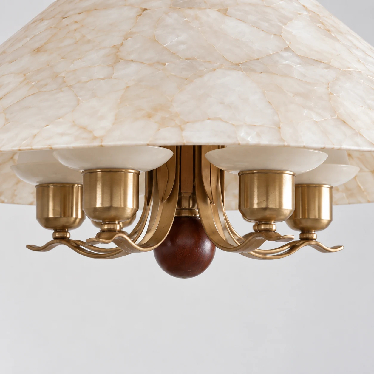 Curved metal arms and the dark wood accent beneath the shade