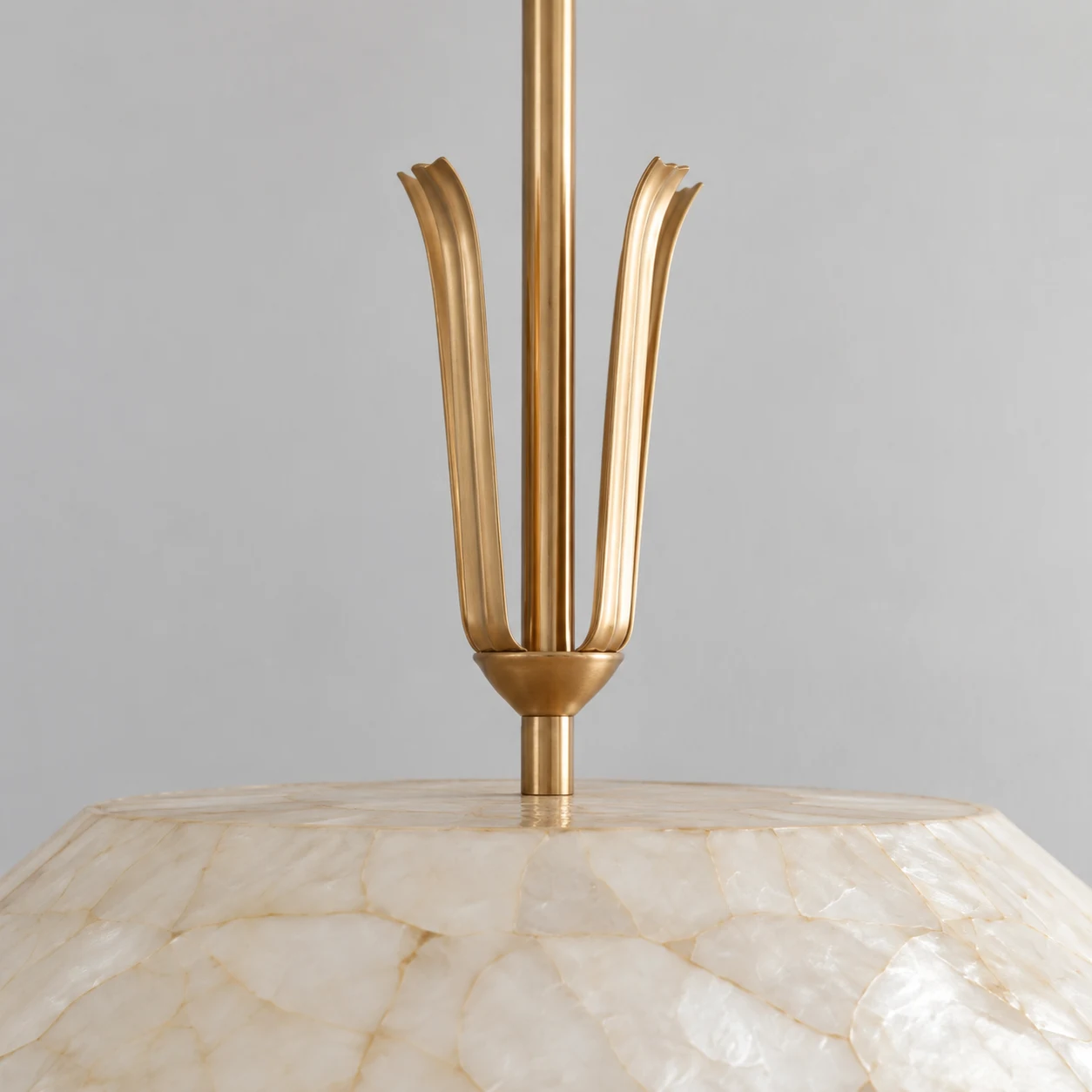 Detail of the slender metal ornament above the shell shade