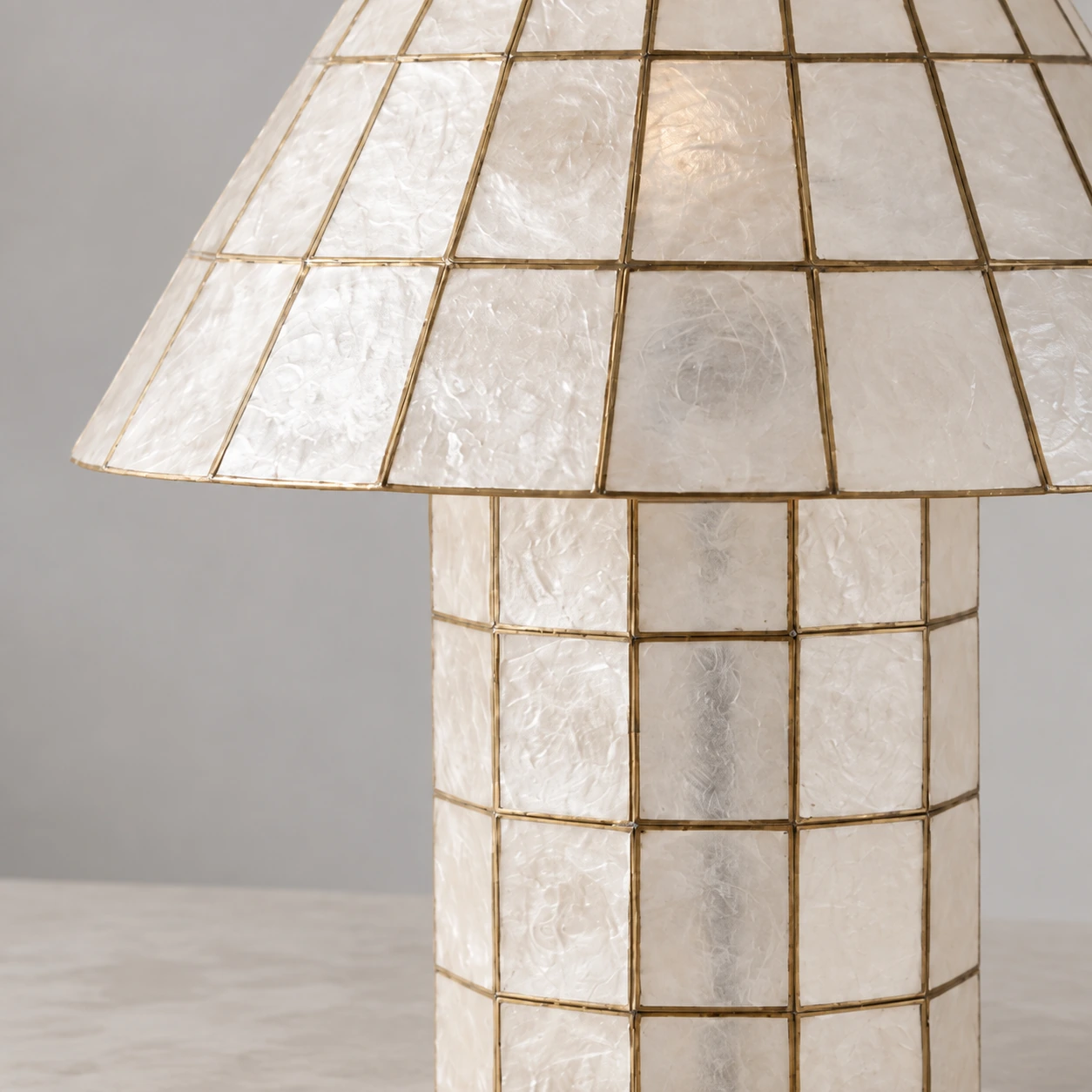 Tapered shell shade meeting the paneled column base
