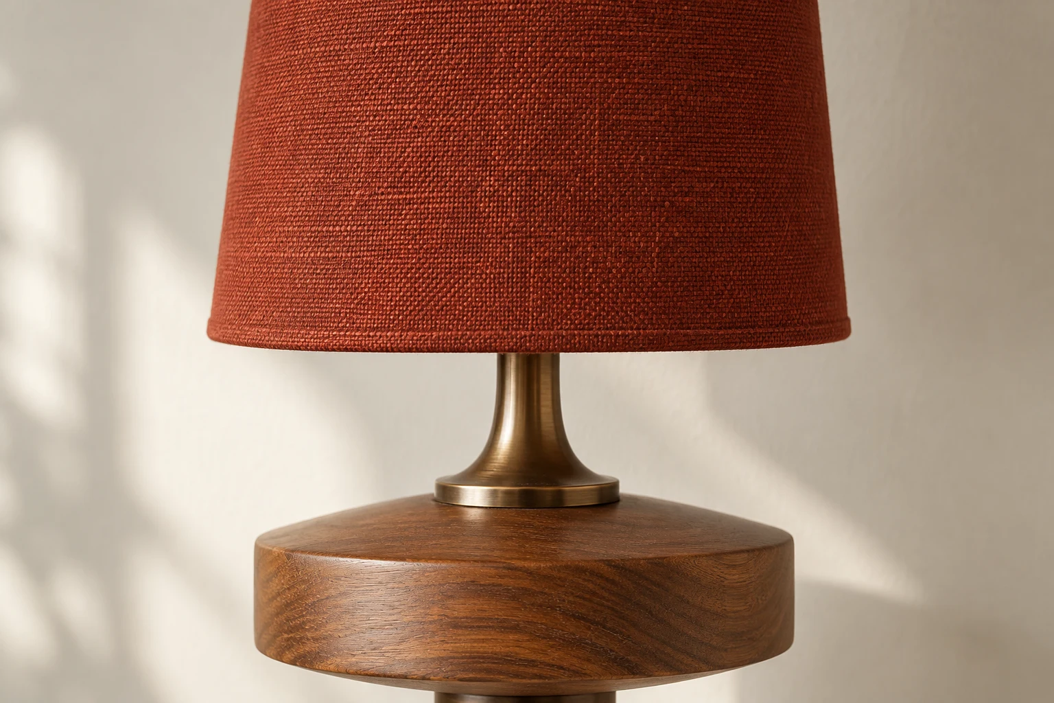 Close-up of brick-red woven fabric shade on wall sconce