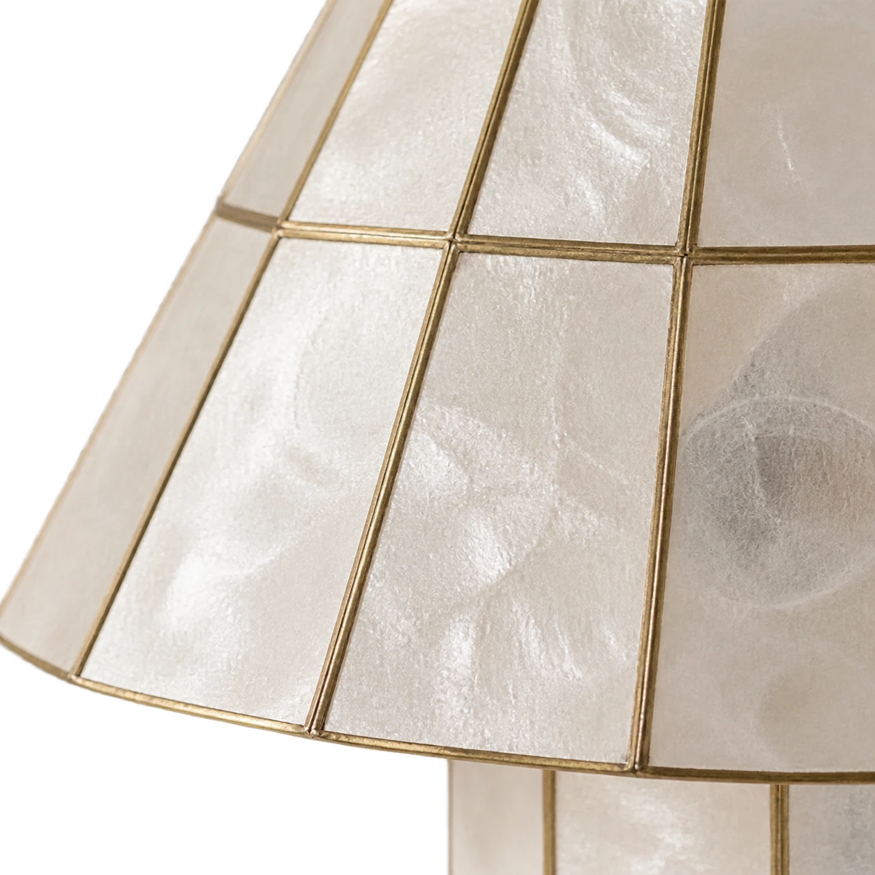 Close detail of ivory shell panels and fine metallic seams