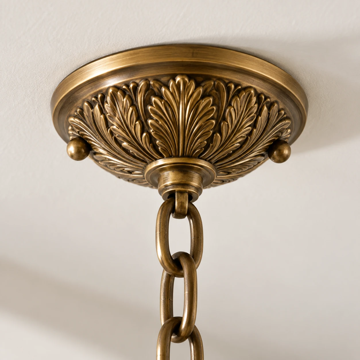 Close view of the relief-patterned ceiling canopy and upper chain connection