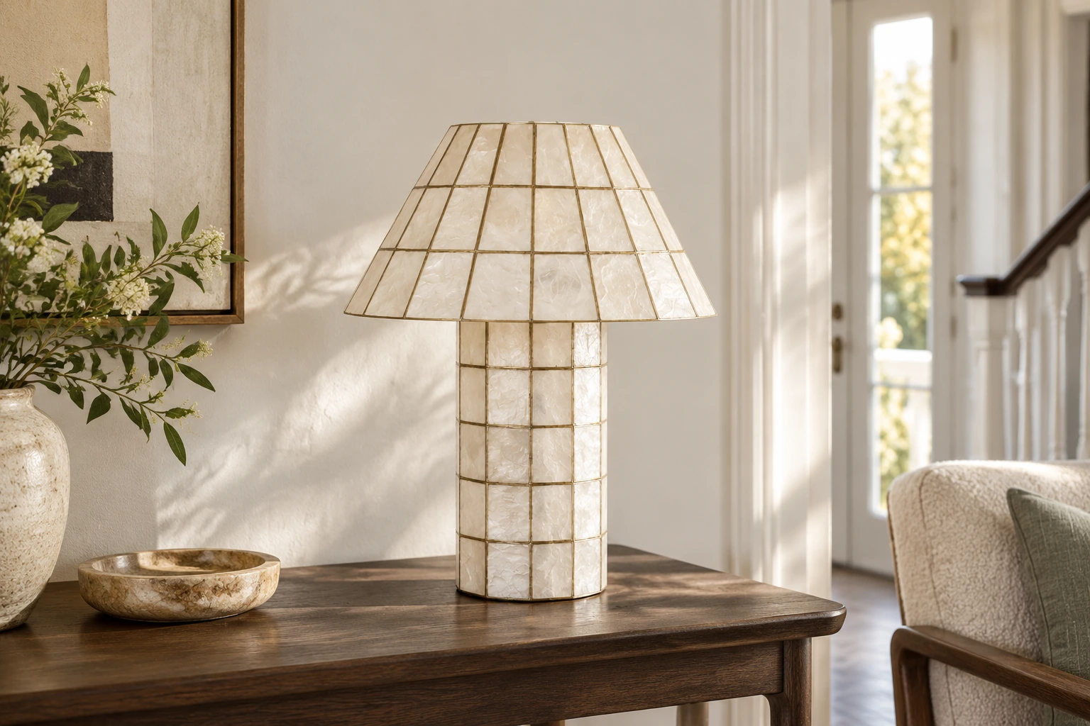 Solenne shell table lamp on a console in a light-filled home