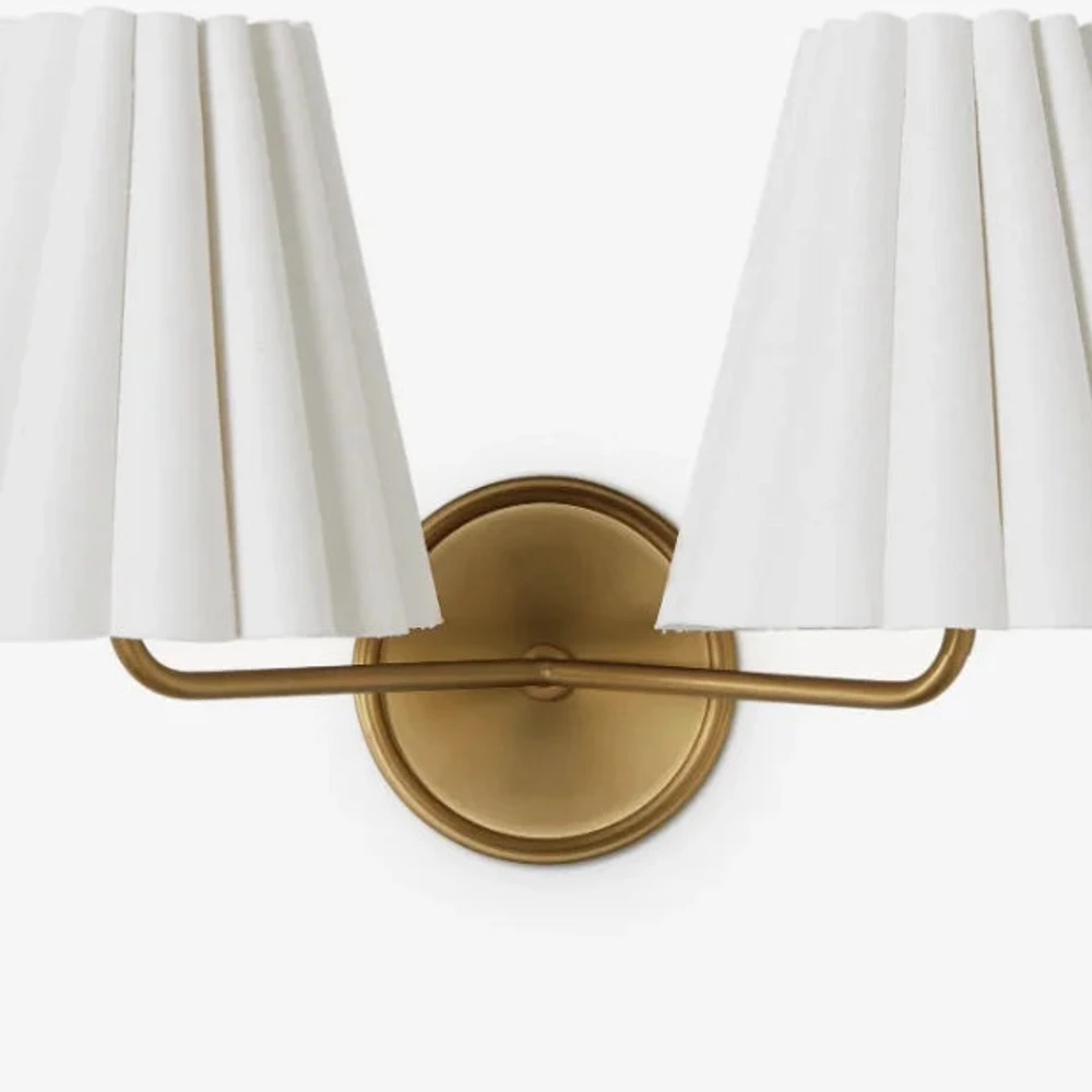 Close view of the brass wall plate and balanced double-light arms
